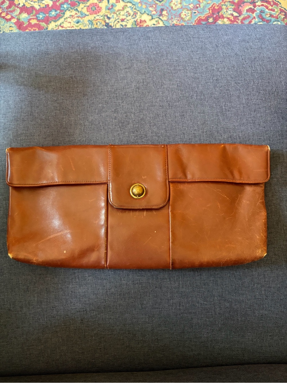 Elongated vintage leather clutch.